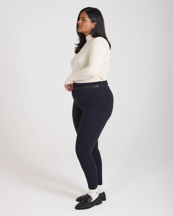 Elegantly poised model wearing Emello's Forma Super Soft Sculpting Leggings in Black, showcasing the form-fitting silhouette.