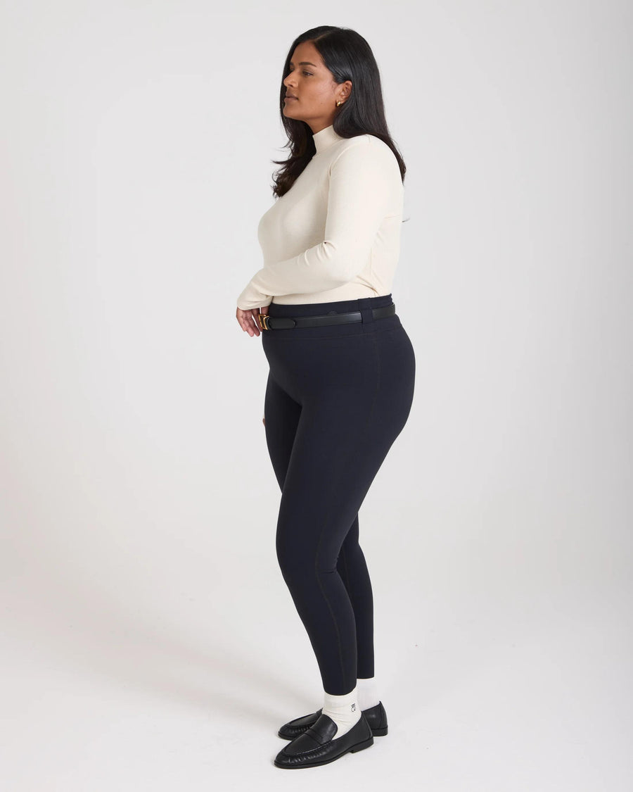Elegantly poised model wearing Emello's Forma Super Soft Sculpting Leggings in Black, showcasing the form-fitting silhouette.