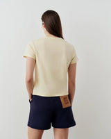 Back view of Emello's Supima Cotton Pocket Tee in butter yellow, showing its elegant regular fit and silky fabric.