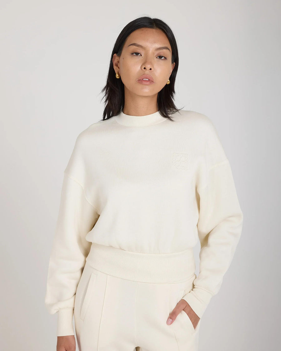 Emello cream sweatshirt with embossed logo, relaxed fit in soft lyocell fleece.