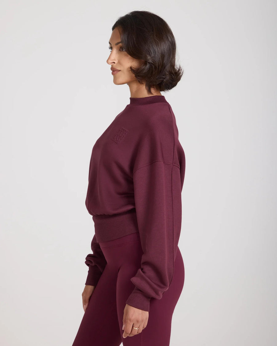 Fig sweatshirt with debossing in buttery-soft lyocell fleece worn by model, side profile showing relaxed fit.