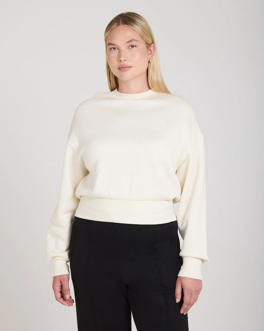 Cream sweatshirt with debossed detailing in lyocell fleece worn by model