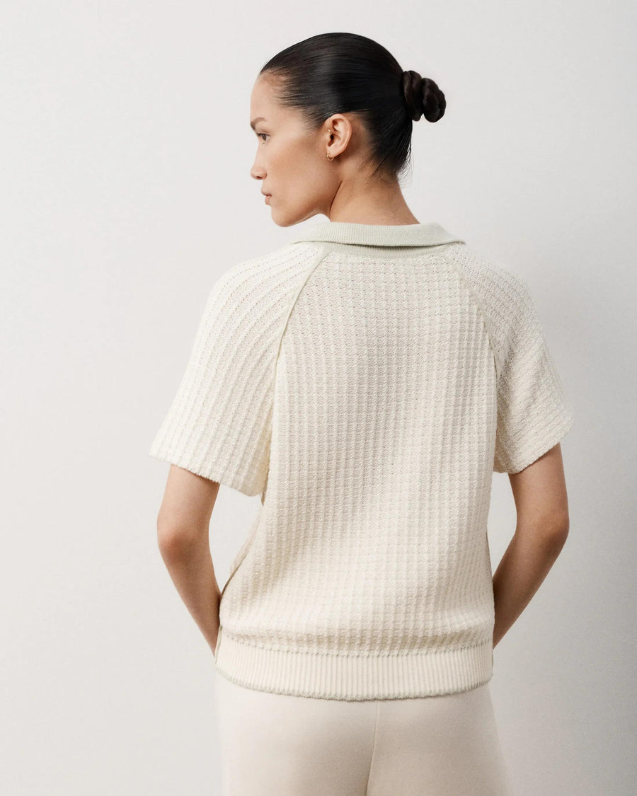 Back view of Emello's textured knit polo top in white tone, showcasing its open-knit construction and relaxed fit.