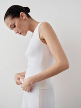 White tonal ribbed knit tank top with wide shoulders and scoop neckline, showcasing Emello's refined elegance.
