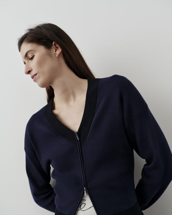 Navy V-neck zip cardigan in organic cotton blend with a relaxed, structured fit.