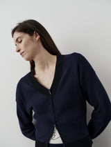 Navy V-neck zip cardigan in organic cotton blend with a relaxed, structured fit.