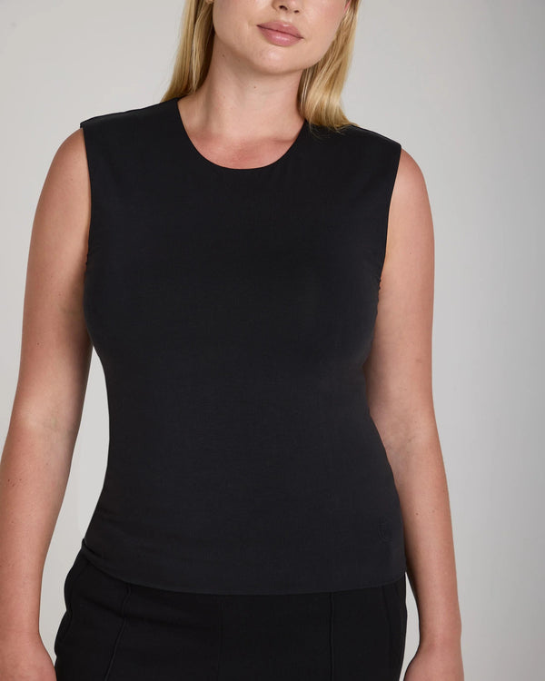 A woman wearing the Emello Forma Silky Lyocell Jersey Double-Layer Vest in black, showcasing a refined silhouette with a crew neck.