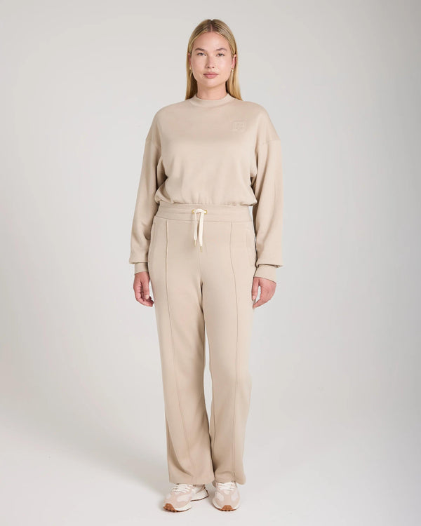 Mello Lyocell Fleece Wide Leg Pants in beige, relaxed fit, worn by model standing in a neutral studio.