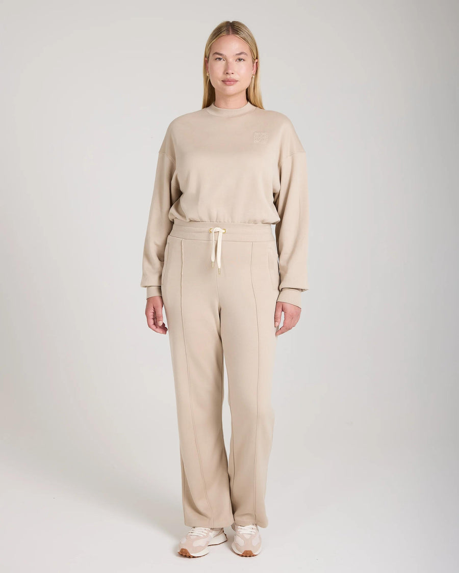Mello Lyocell Fleece Wide Leg Pants in beige, relaxed fit, worn by model standing in a neutral studio.