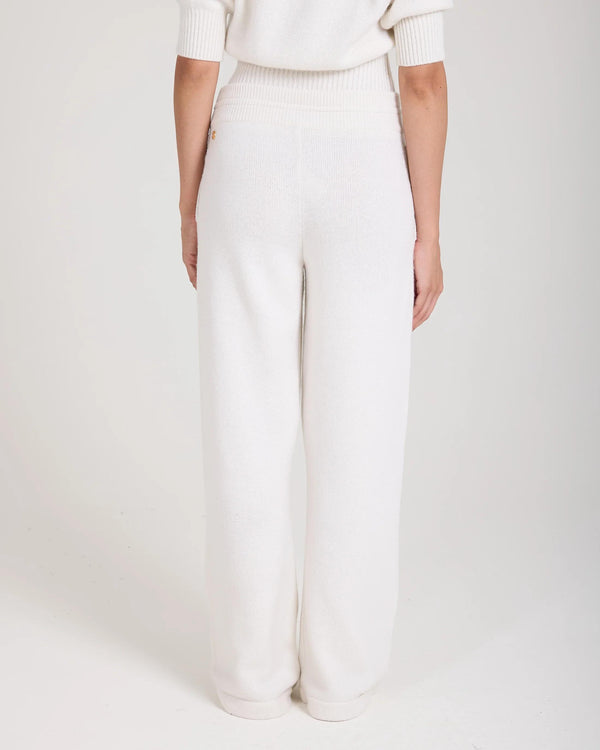 Back view of cream wide-leg trousers in a luxurious merino wool and cashmere blend, featuring ribbed waistband and gold hardware.