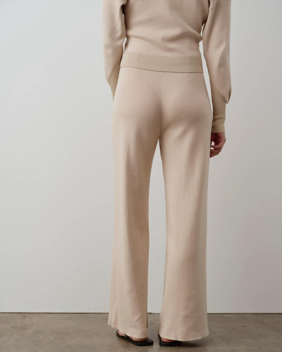 Back view of Emello's Double Waistband Knitted Trousers in neutral, wide-leg design.
