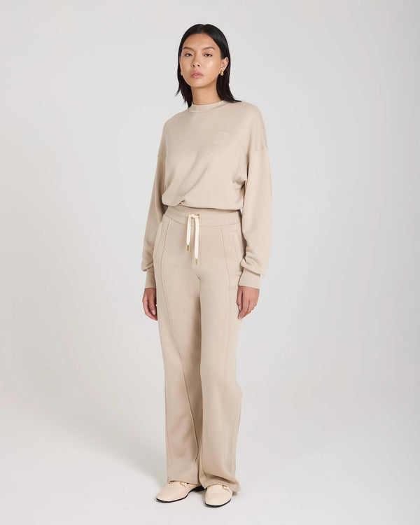 Mello Lyocell Fleece Wide Leg Pants in Beige with gold accents, showcasing relaxed elegance.