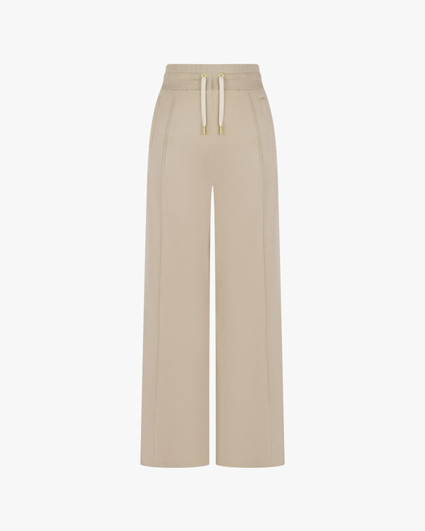 Beige wide-leg Lyocell trousers with gold-finish accents and double-layer drawcord waistband, front view.