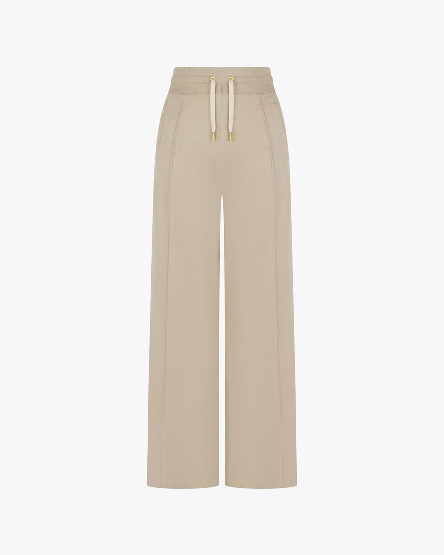 Beige wide-leg Lyocell trousers with gold-finish accents and double-layer drawcord waistband, front view.