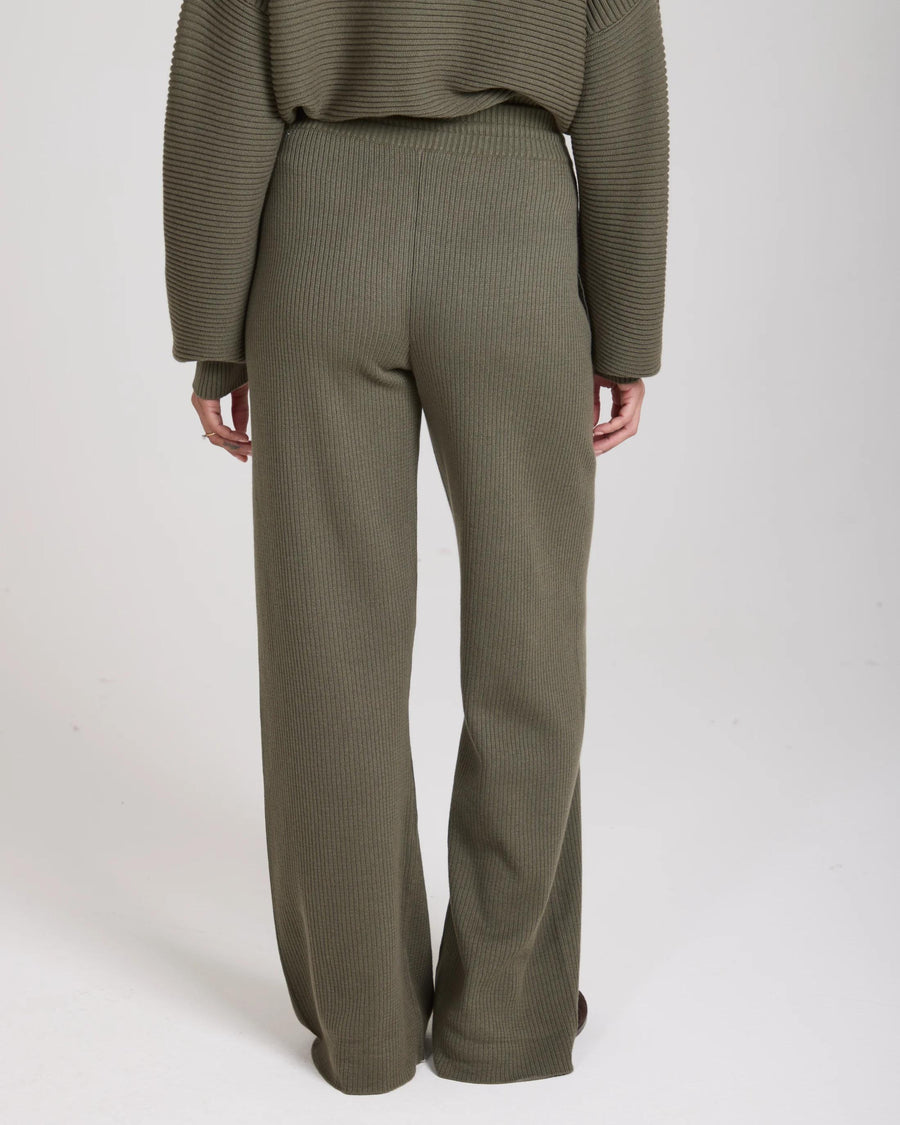Olive ribbed wide-leg trousers with an elastic waistband, viewed from the back.